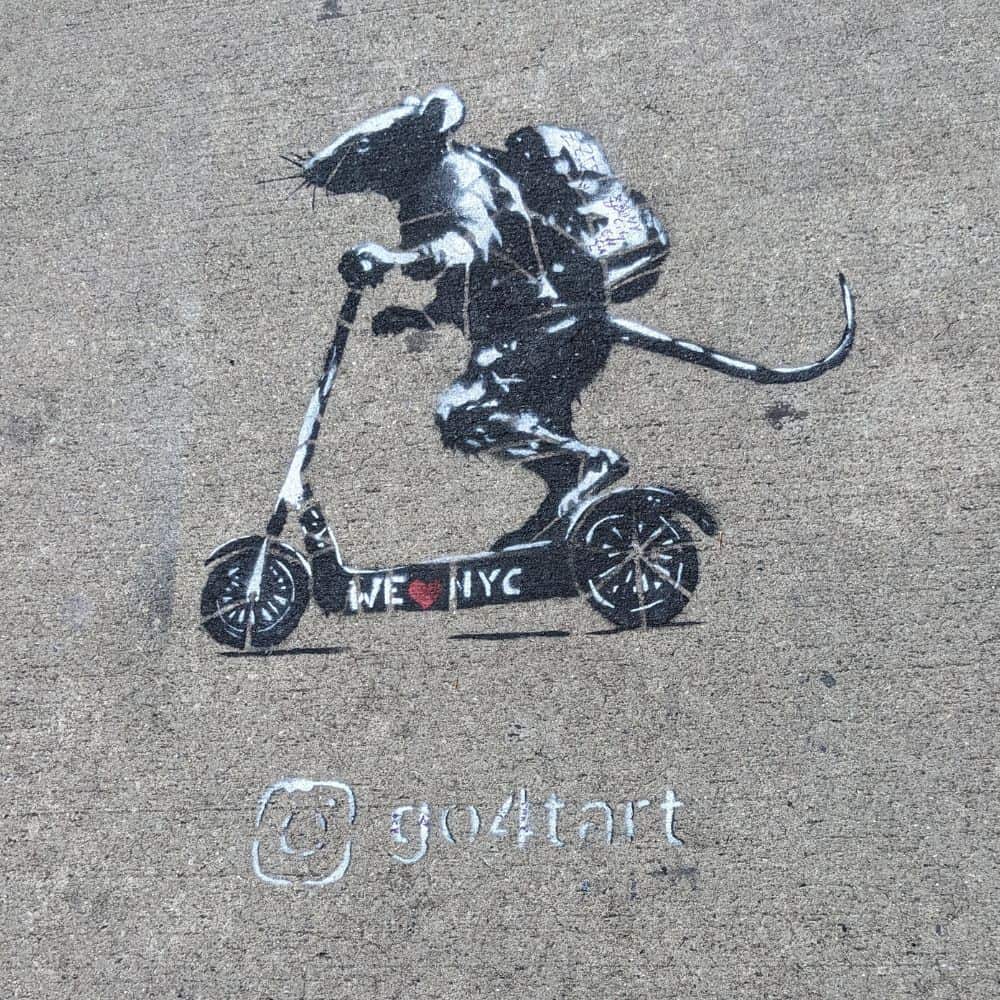 Stencil and spray paint art of a rat wearing a backpack riding a scooter that says "I heart NYC"